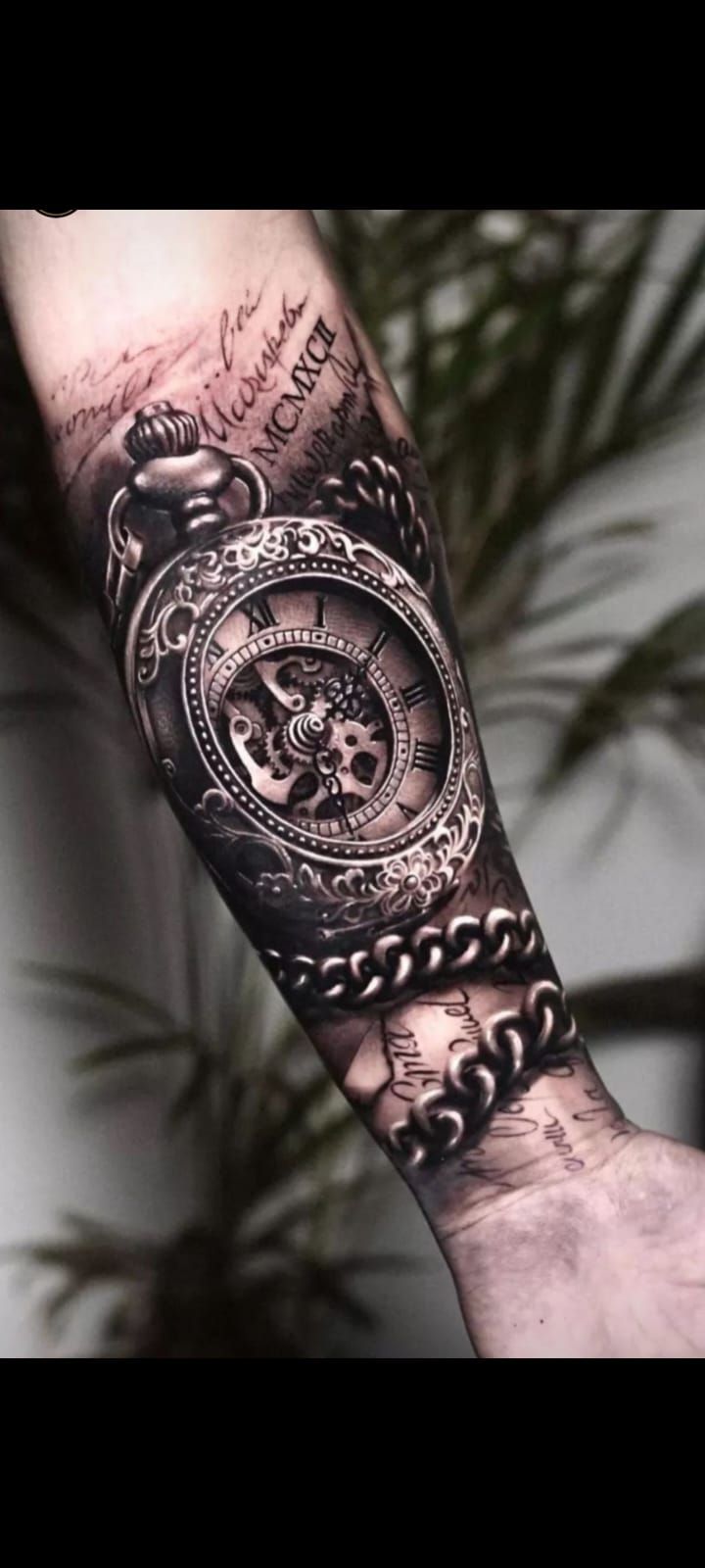 a man's arm with a clock and chain tattoo on the forearm, in black and white