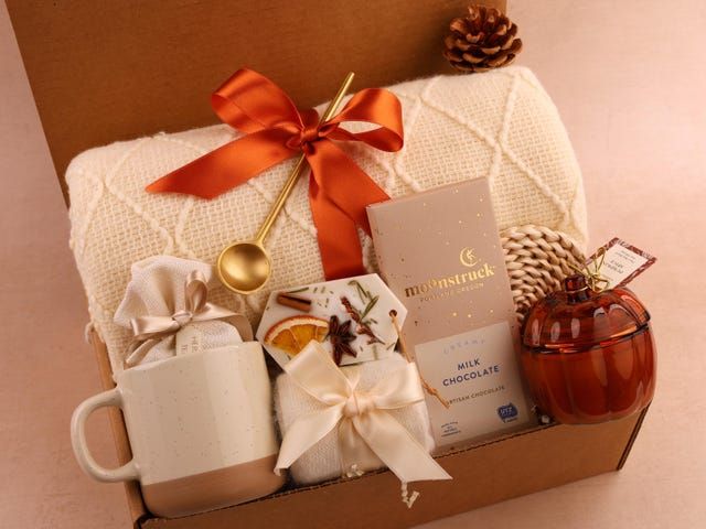 a gift box with coffee, tea and other items in it sitting on a table