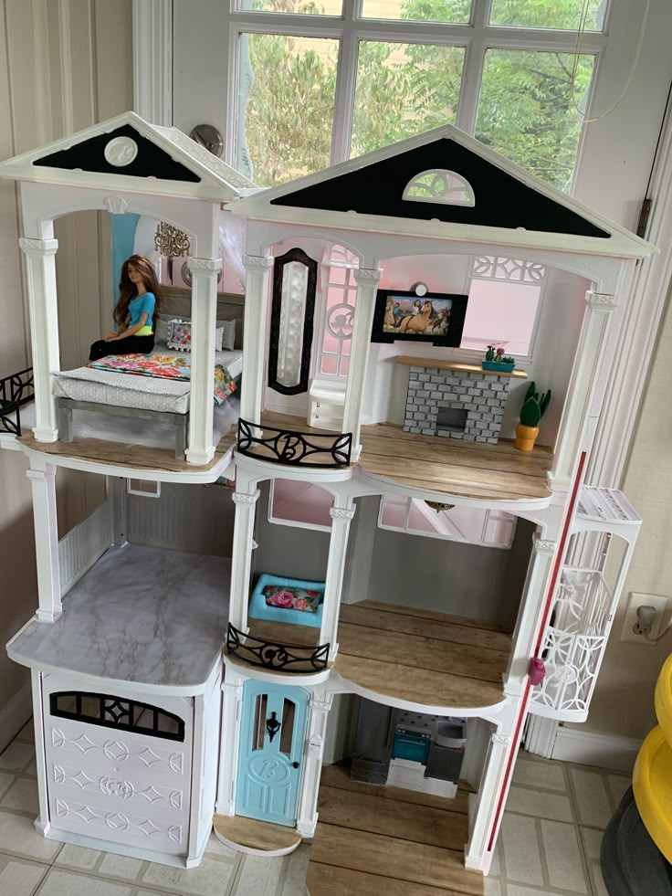 a doll house with all the furniture and accessories in it's playroom area