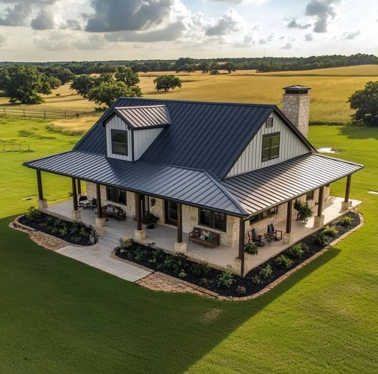 an aerial view of a house in the middle of a field