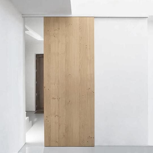 an empty room with white walls and wooden doors