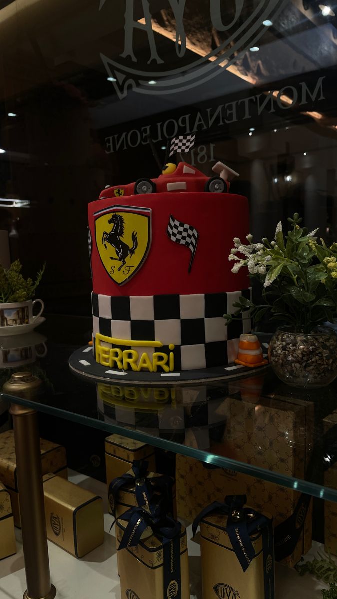 there is a cake that looks like a ferrari racing car on display in the store