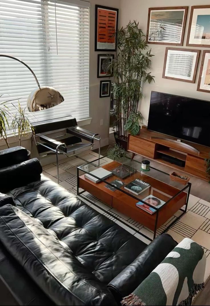 a living room filled with furniture and a flat screen tv mounted on a wall above a wooden coffee table