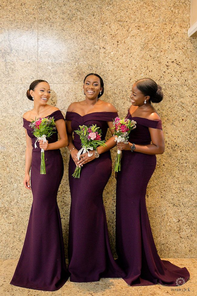 three women in long purple dresses standing next to each other and smiling at the camera