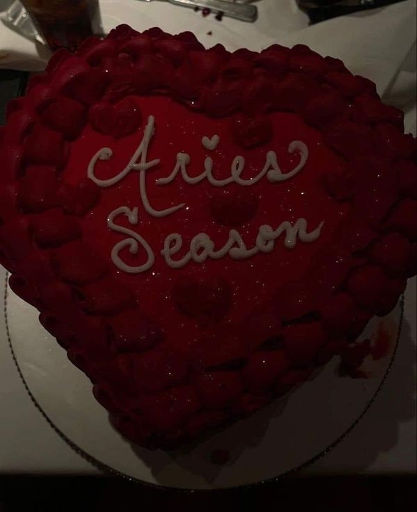 a heart shaped cake with the words ariies season written on it