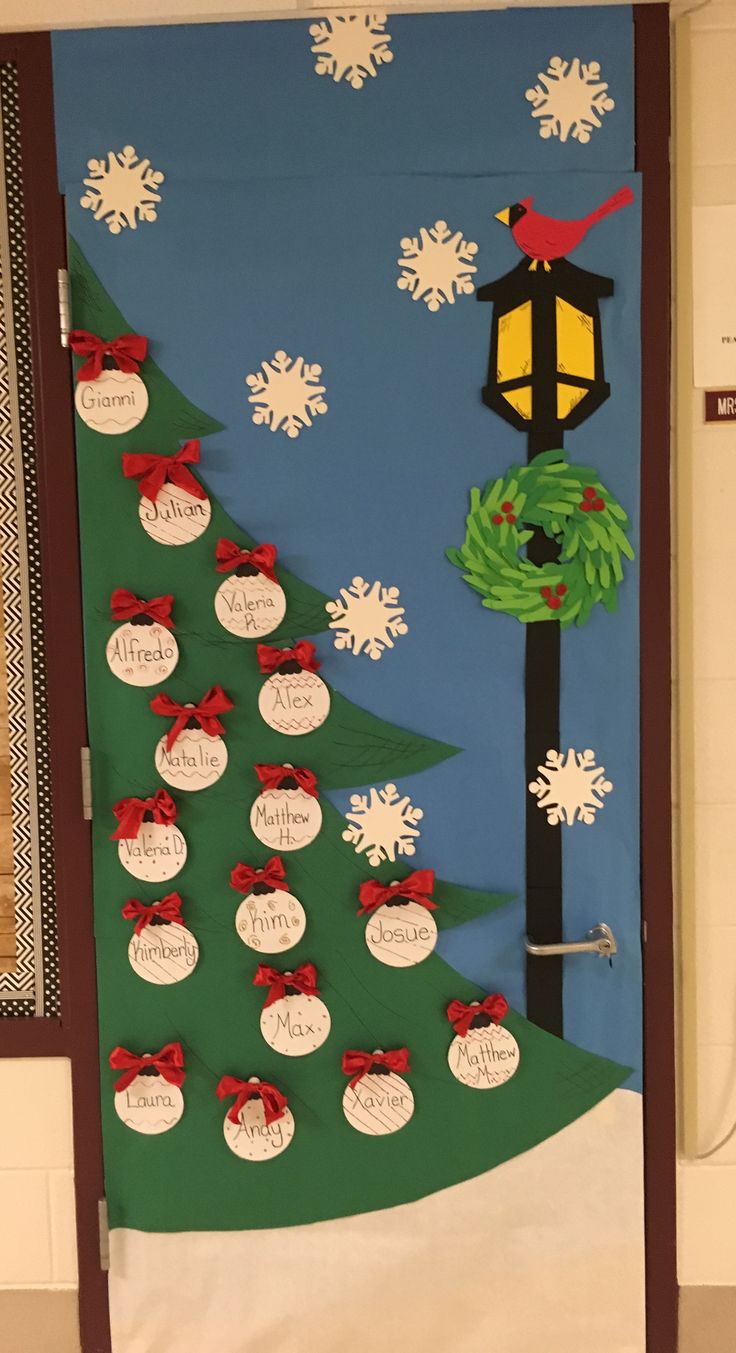 a door decorated with christmas decorations and paper snowflakes on the front, along with small trees