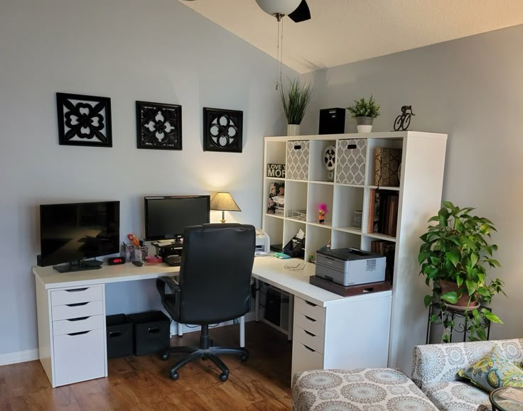 a home office with two computer screens on the desk and a chair in front of it