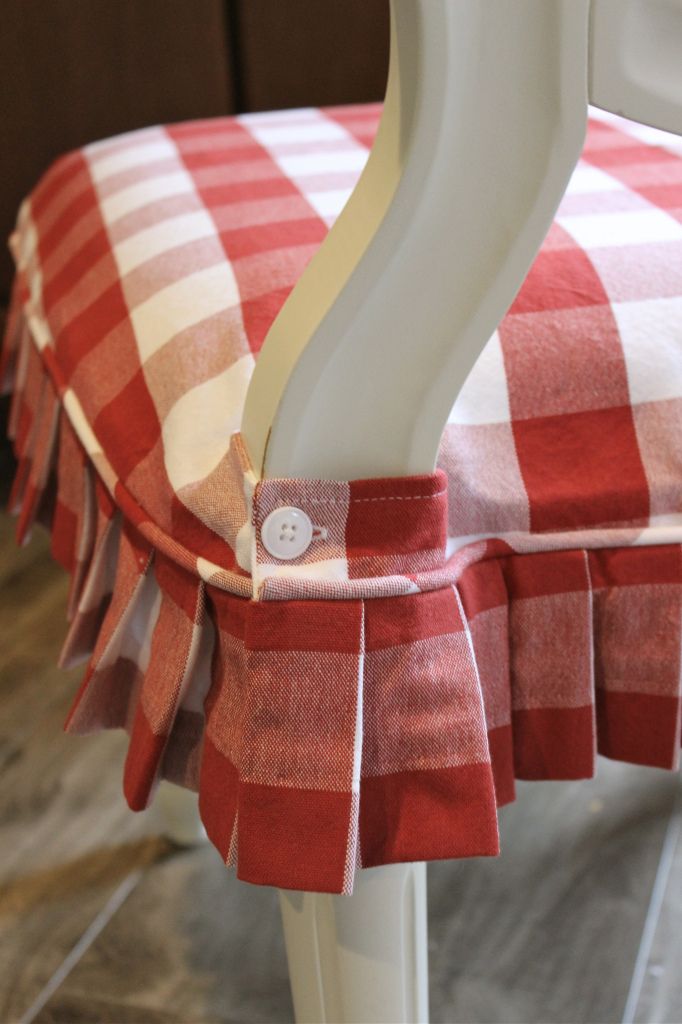 a red and white checkered chair with a button on the back of it's seat