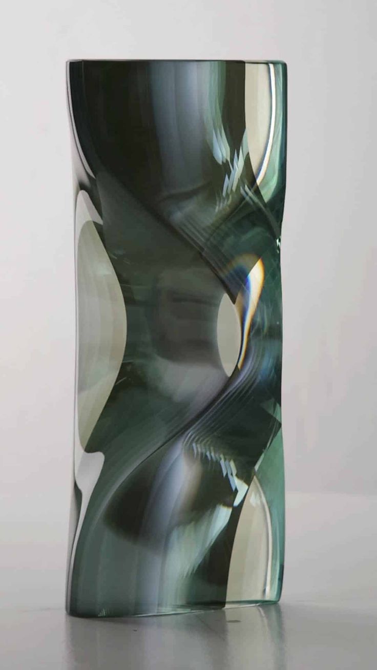 an abstract glass sculpture sitting on top of a table