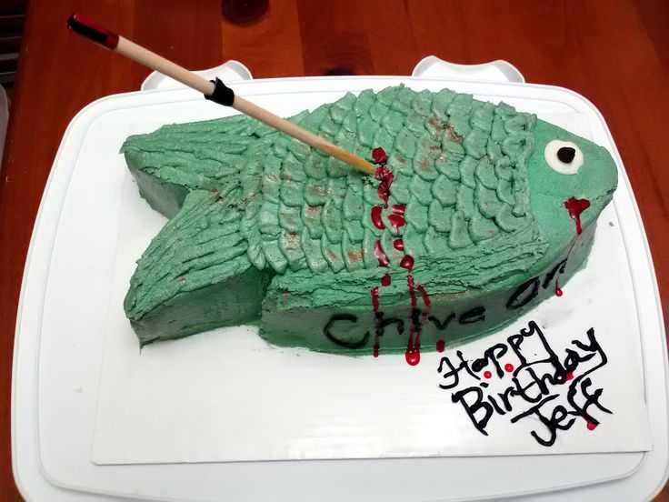 a birthday cake with a green fish on it