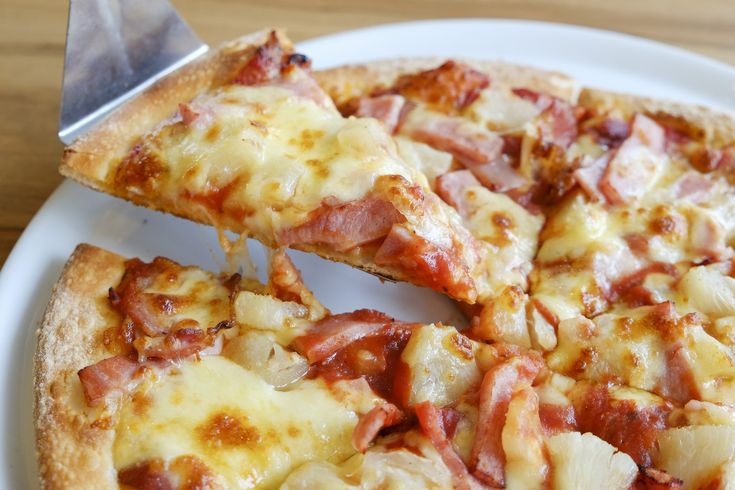 the pizza is cut into four pieces and ready to be eaten with a spatula in australia, according for 15 % of pizza sales