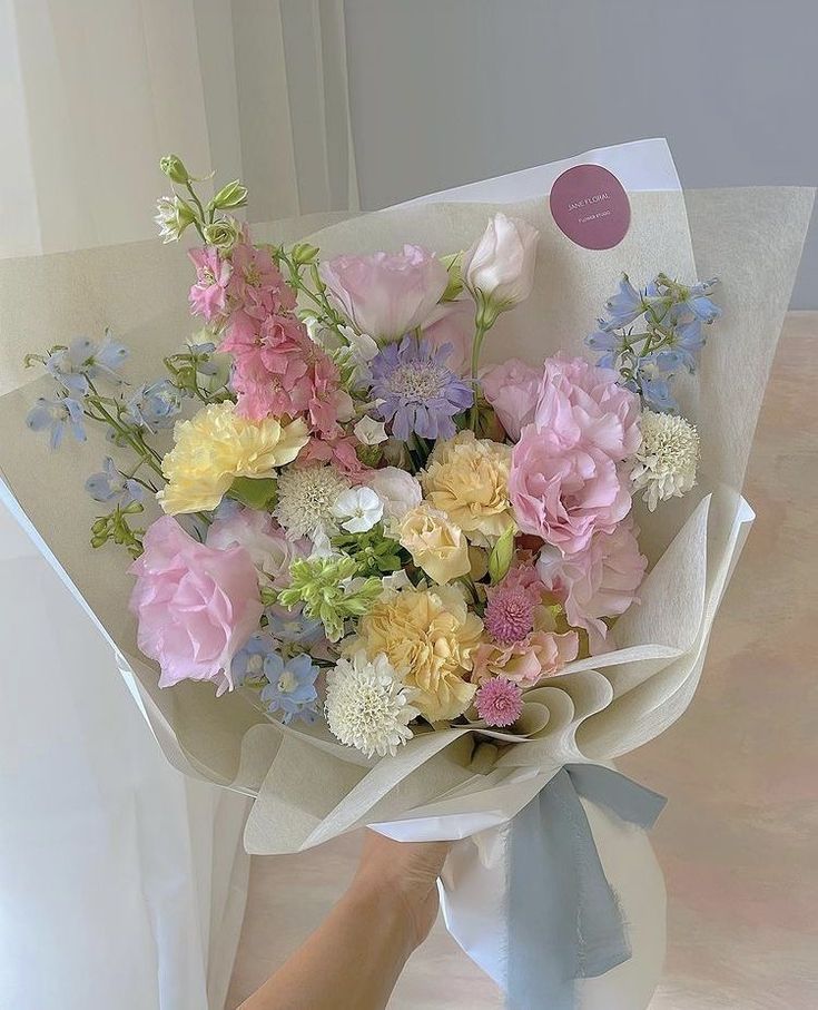 a person is holding a bouquet of flowers