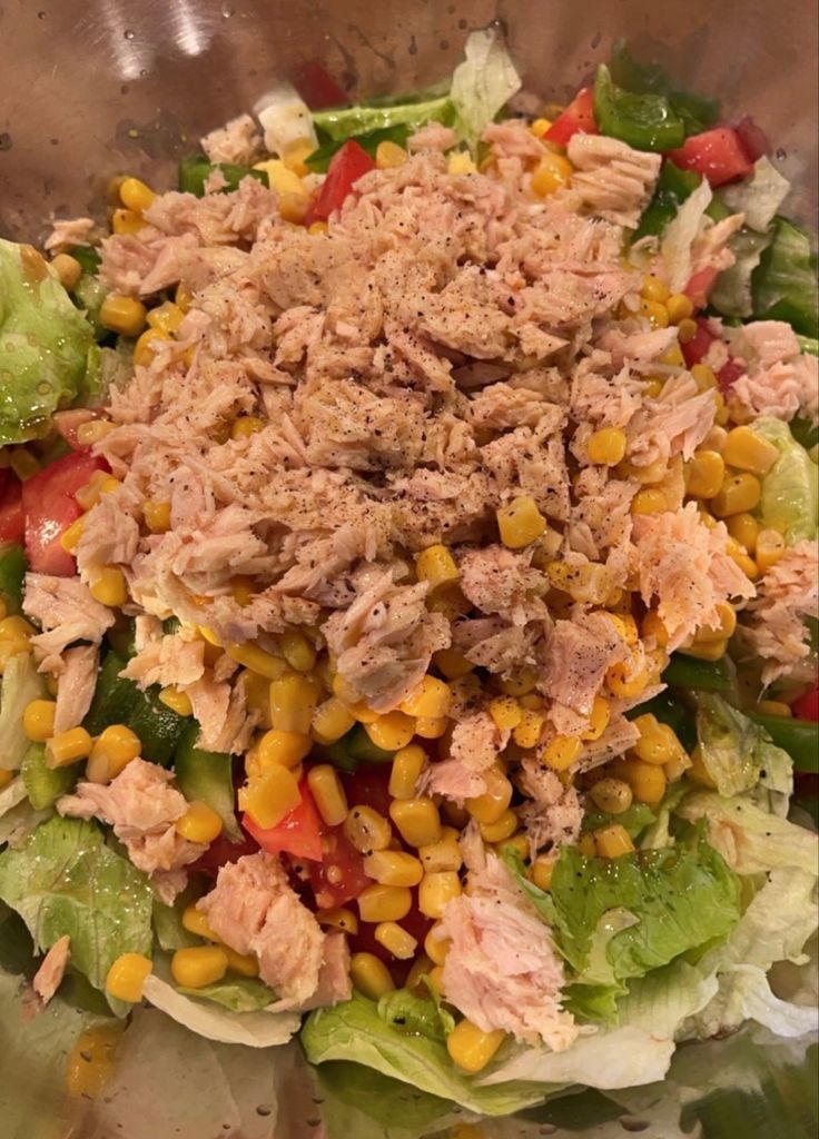 a salad with tuna and corn in a bowl