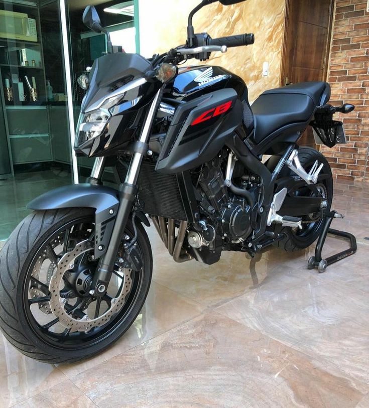 a black motorcycle parked in front of a building