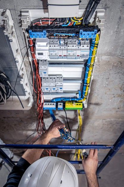 a man is working on an electrical panel