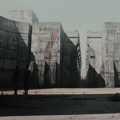 two people are standing in front of some concrete structures that look like they have been built into the ground