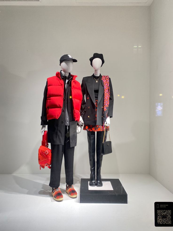 two mannequins dressed in black and red outfits