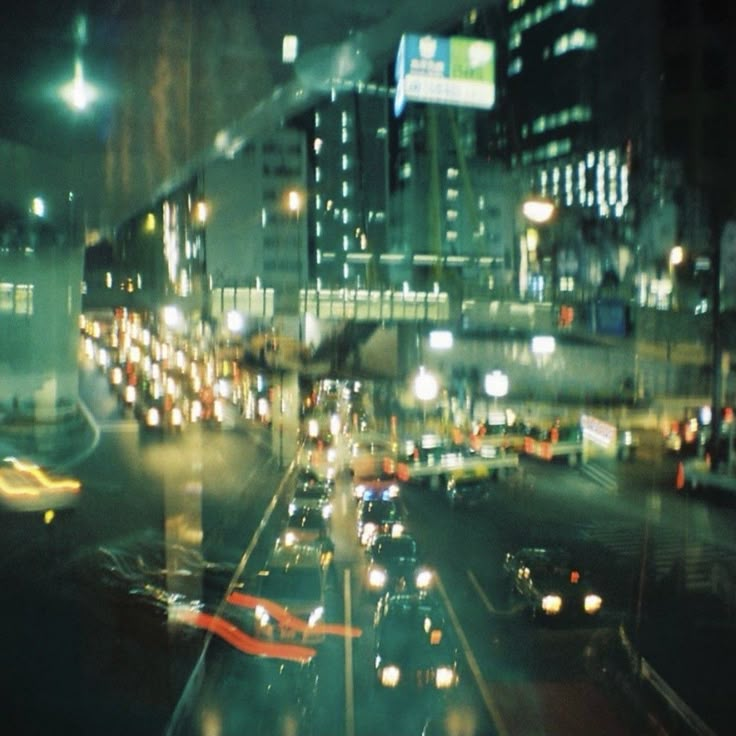 the city street is filled with lots of traffic at night, including cars and buses