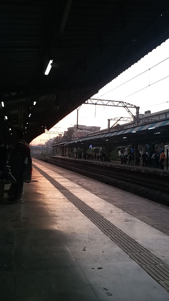 people are waiting at the train station for their trains to arrive and go out on the tracks