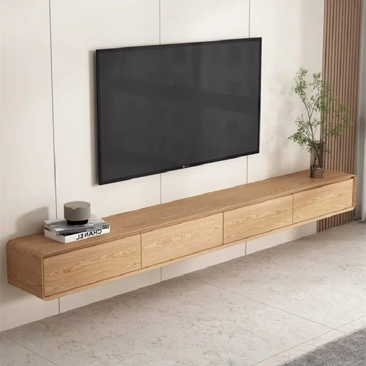 a flat screen tv mounted to the side of a wall