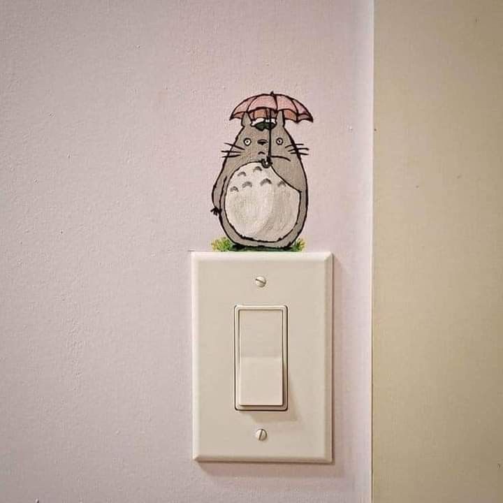 a push light switch with a cartoon character on it's cover and an umbrella over its head