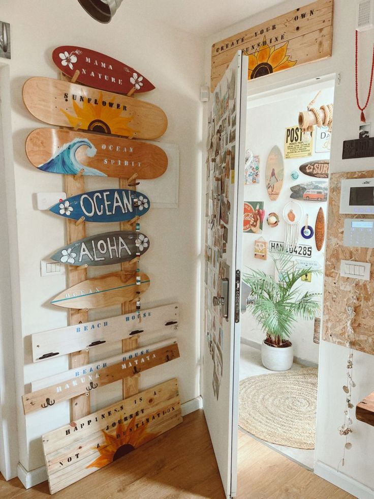 there are many surfboards mounted to the wall in this room and it looks like they have been made out of wood