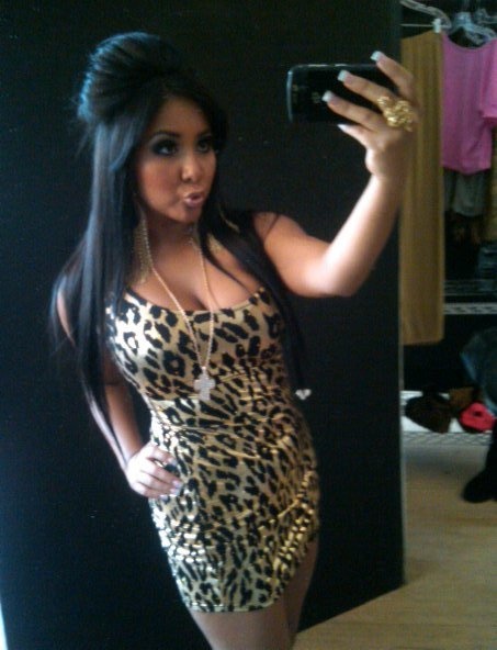 a woman taking a selfie in a leopard print dress