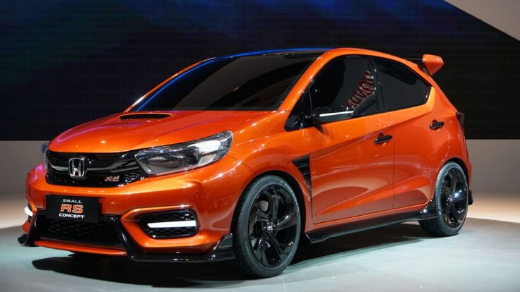 an orange car is on display at the show