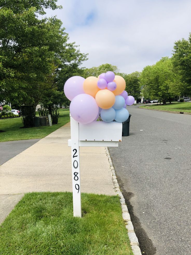 a mailbox with balloons attached to it