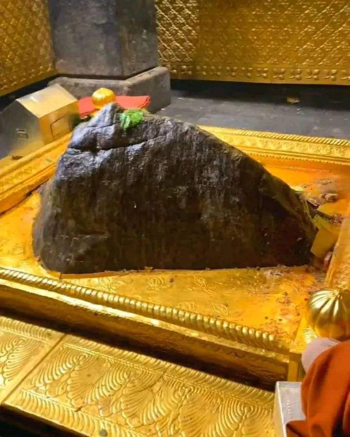 a large rock sitting on top of a golden table