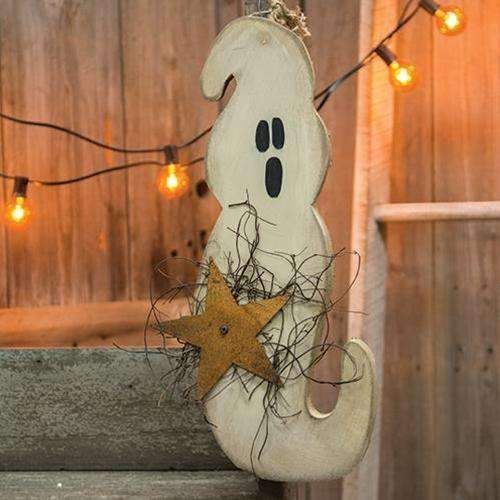 a wooden ghost hanging from a string with lights around it and a star on the bottom