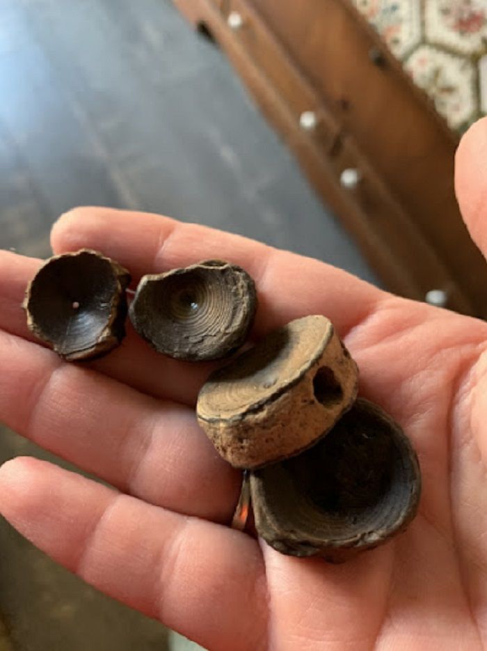 a person holding three pieces of wood in their hand