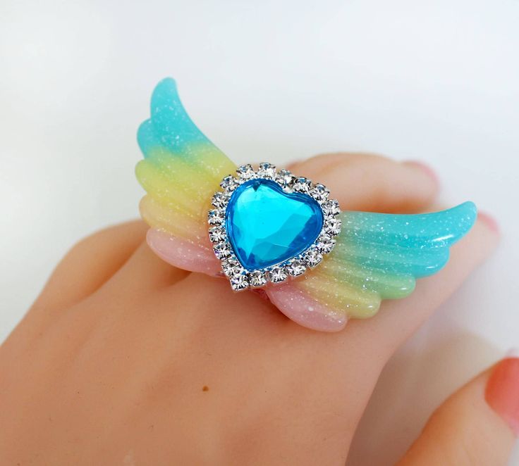 Resin Glitter Ring - Glitter Wings Jewelry - Glitter wings ring - Heart Ring - Kawaii Ring - Valentine Gift - Heart Wing Jewelry-Kawaii Ring - Harajuku Fashion - fairy Tale Jewelry this listing is for a lovely angel wings ring with a beautiful heart in the middle. The ring is handmade out of resin. You will get exactly the same as shown on the picture. The pink filigree ring is adjustable. The wings are 7 cm large (2.5 inch) some parts are not compatible with water and shouldn't be submerged. ju Cute Heart Ring For Gift, Cute Party Ring Jewelry, Cute Adjustable Party Rings, Adjustable Cute Party Rings, Cute Adjustable Rings For Parties, Kawaii Ring, Angel Wings Ring, Mode Harajuku, Wings Jewelry