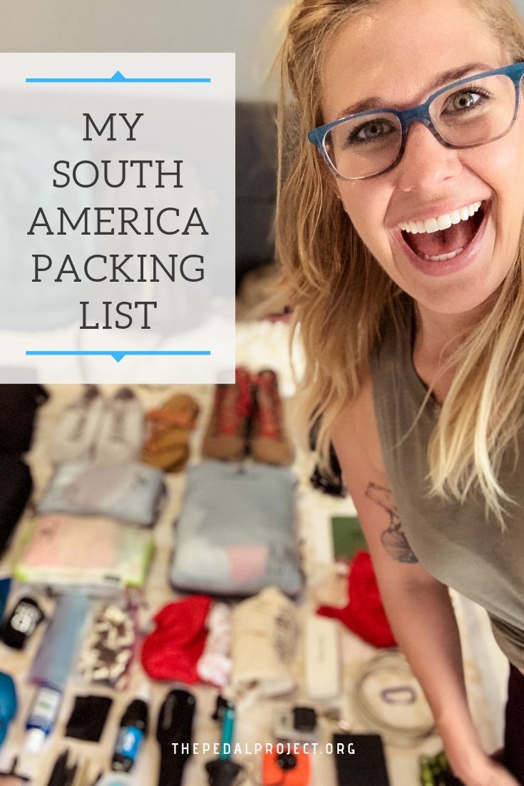 a woman with glasses is standing in front of many items on the floor and has her mouth open