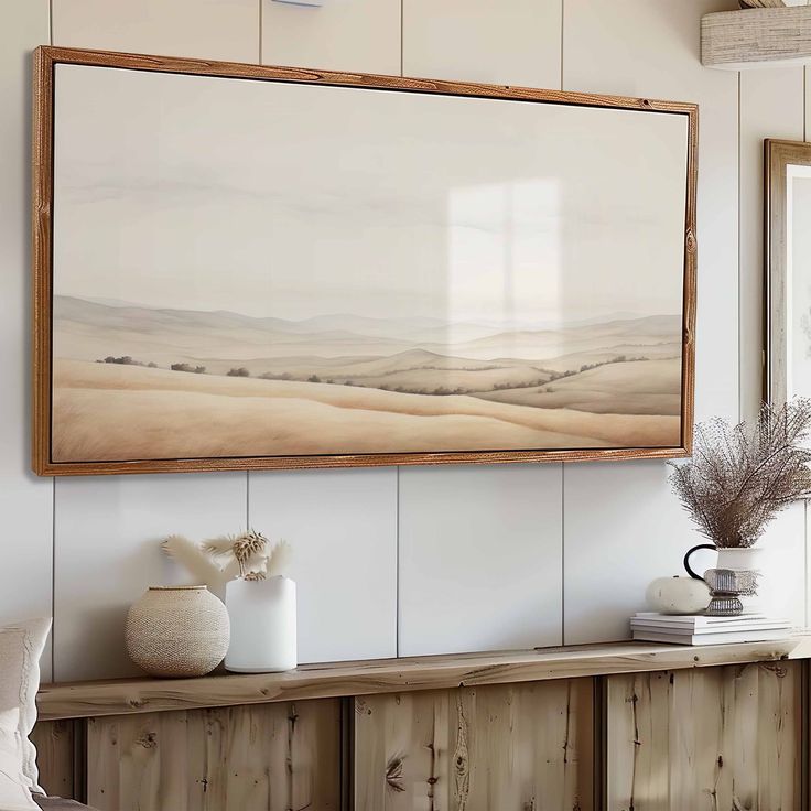 a painting hanging on the wall above a wooden shelf