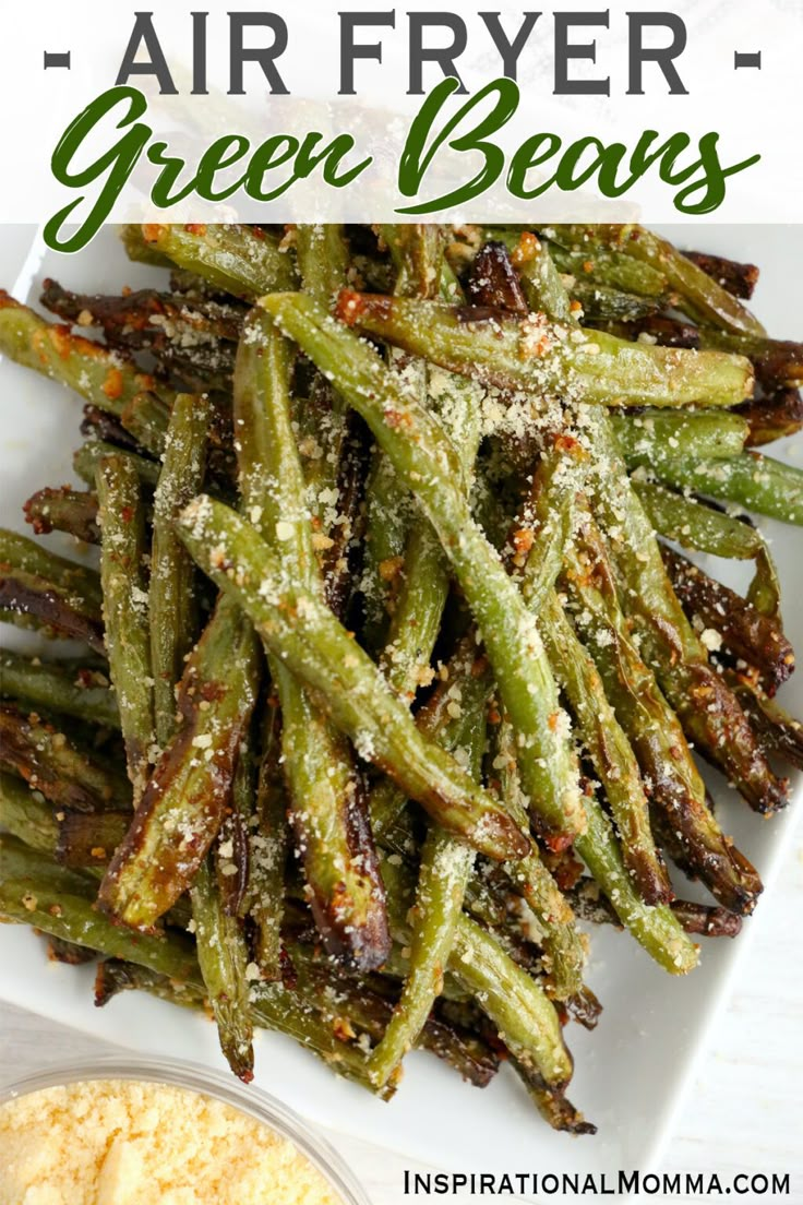 air fryer green beans on a white plate with parmesan sprinkles