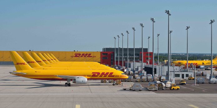 an airplane is parked on the tarmac with other planes in the background