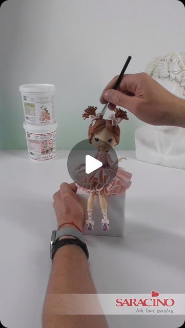 someone is making a doll out of paper