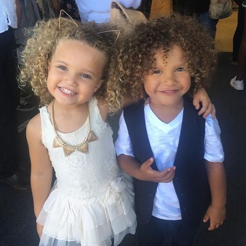 two young children are posing for the camera