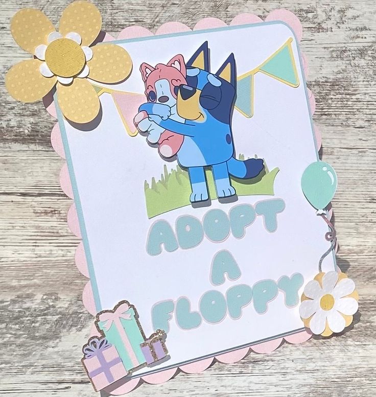 a greeting card with an image of a cat holding a balloon and the words adopt a floppyy on it