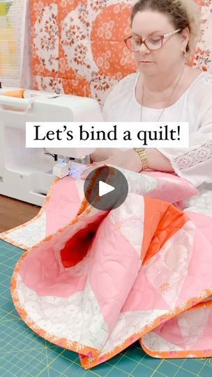 a woman sitting on top of a table next to a sewing machine with the words let's bind a quilt