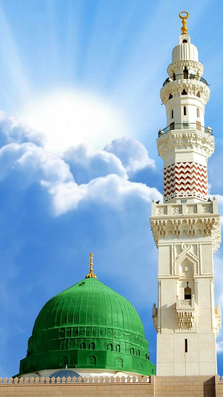 a tall white building with a green dome on it's side and clouds in the background