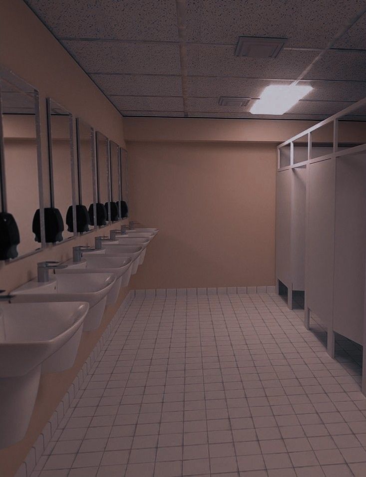 a row of sinks and mirrors in a bathroom with tile flooring on the walls