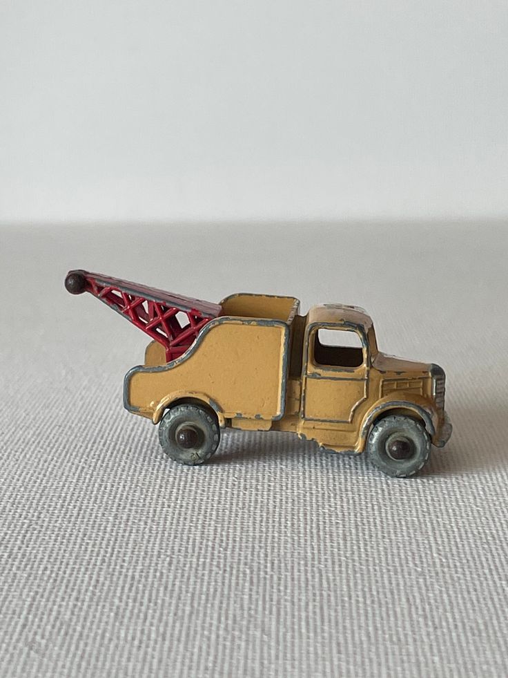 a toy truck with a crane on the back