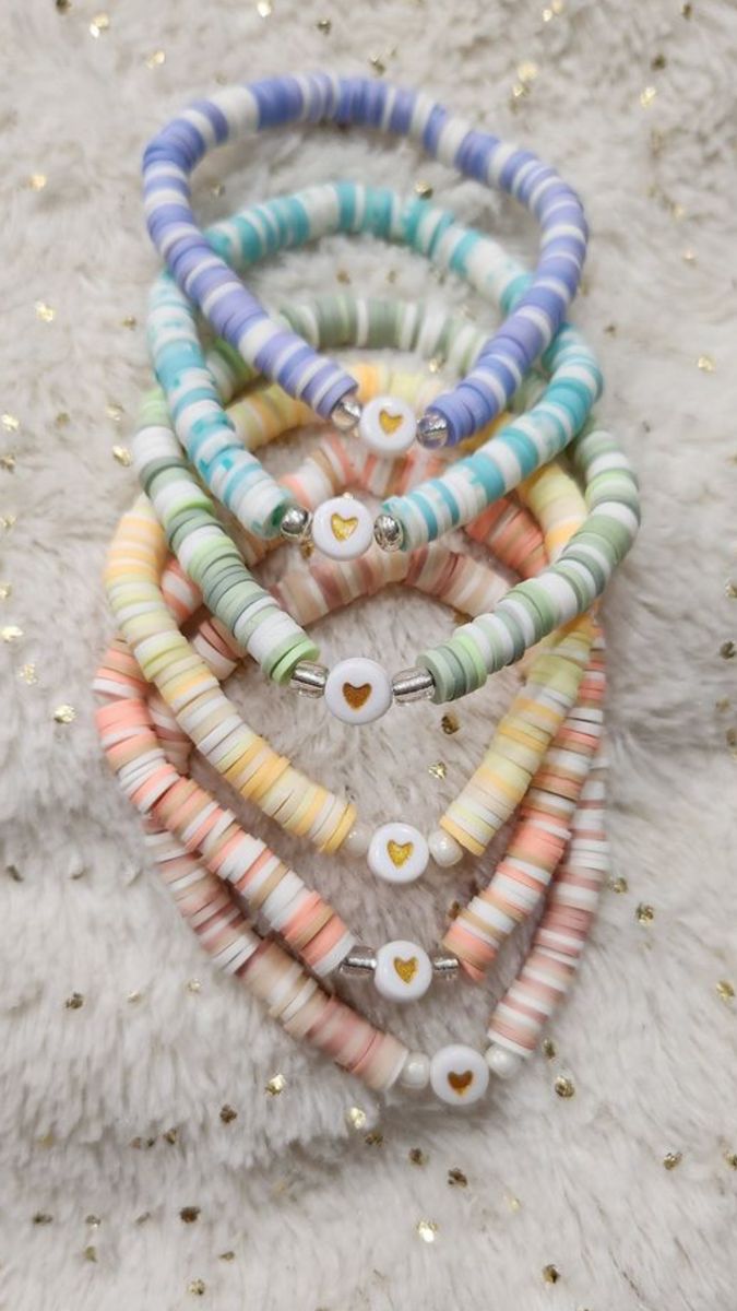 multicolored bracelets with buttons on them sitting on a white furnishing