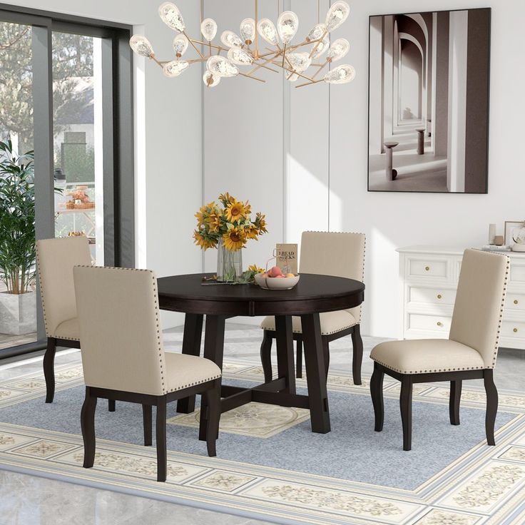 a dining room table with white chairs around it