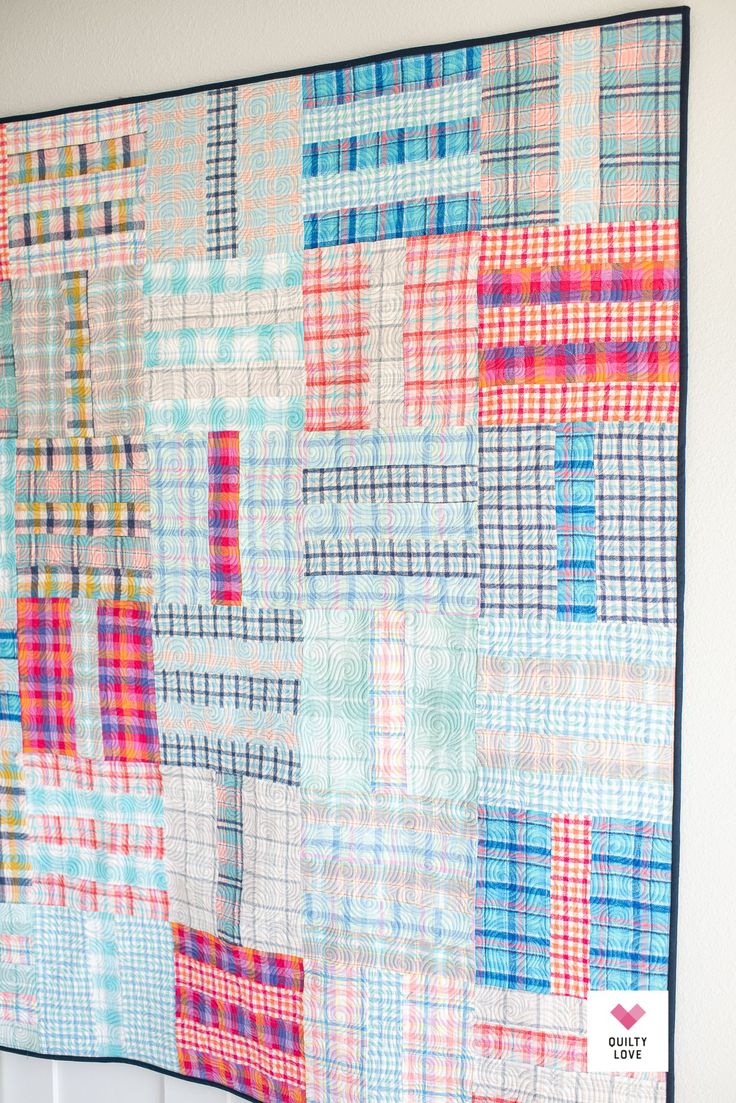 a colorful quilt hanging on the wall