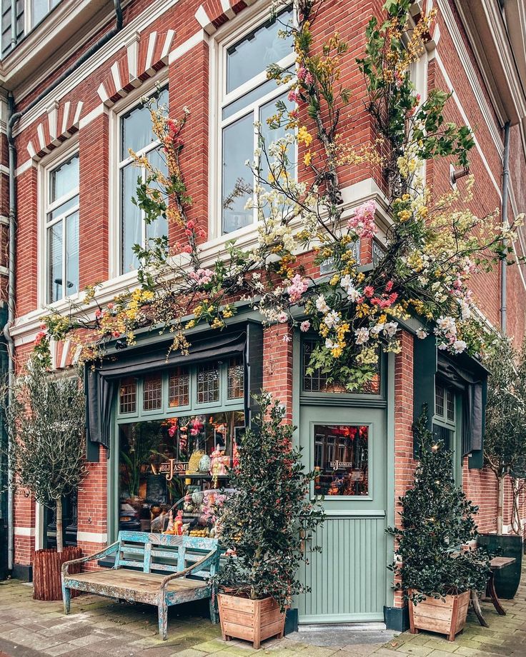 an old brick building with potted plants on the outside