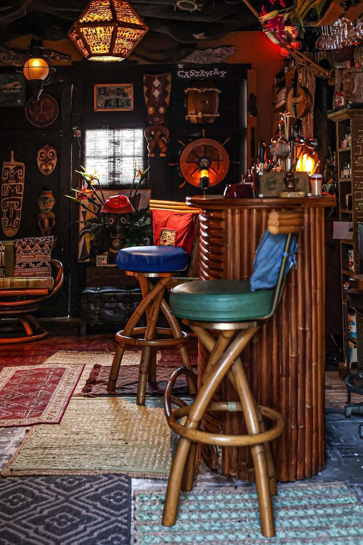 a room filled with lots of different types of furniture and decor on the walls next to a bar