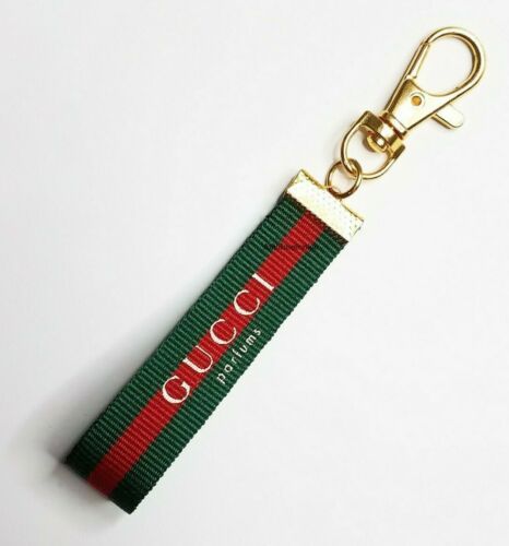 a gucci keychain with a red and green stripe on it